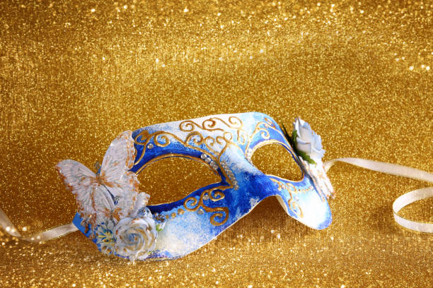 istock elegant venetian mask on gold glitter background 640125456
