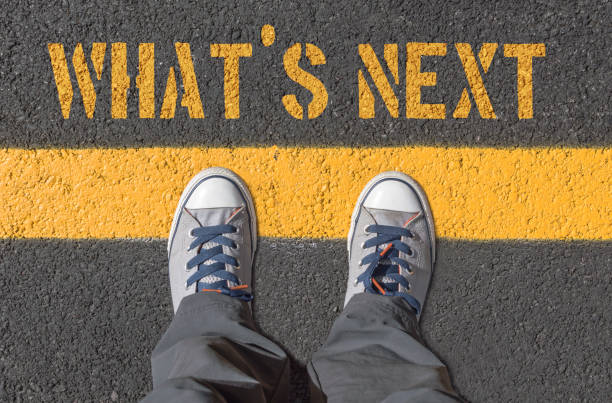 istock WHAT`S NEXT print with sneakers on asphalt road. 640126798