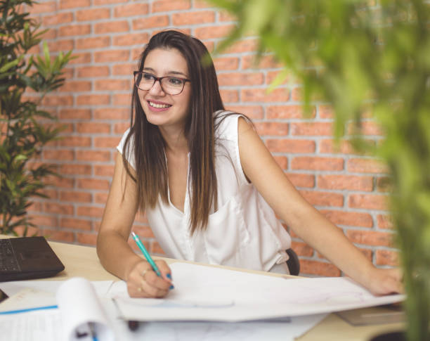 istock Young woman architect in office 640130502