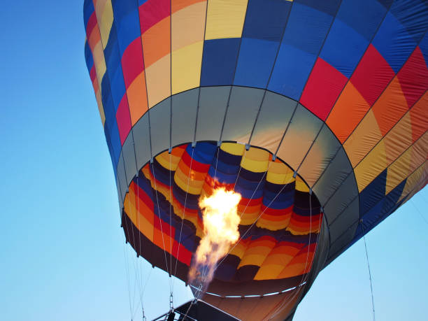 Colorful hot air balloon with flame stock photo