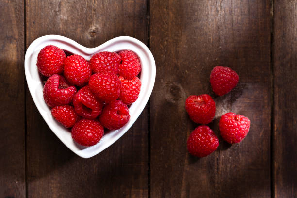 istock Healthy eating concept: heart shaped bowl filled with raspberries 640131902