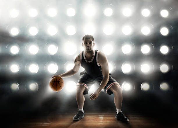 istock basketball player on floodlight background and parquet with ball 640132876