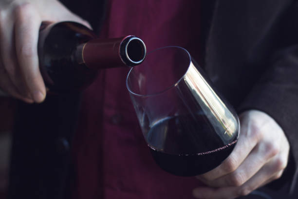 istock Man pouring red wine into a glass 640133244