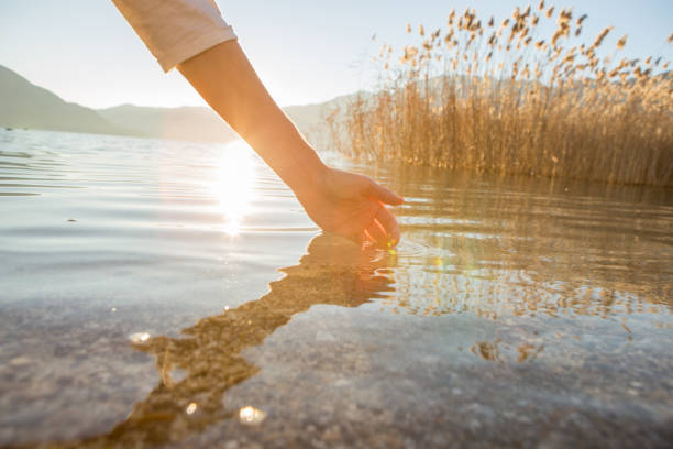 istock Human hand cupped to catch fresh water from mountain lake 640133652
