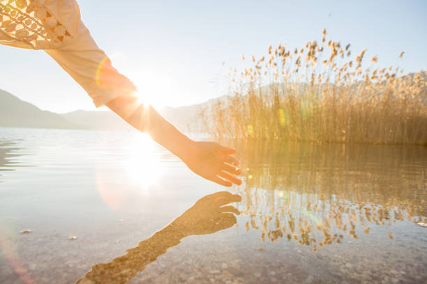 istock Human hand cupped to catch fresh water from mountain lake 640133754