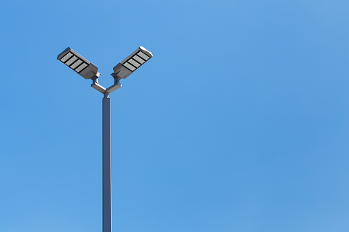 LED streetlight against a blue sky.