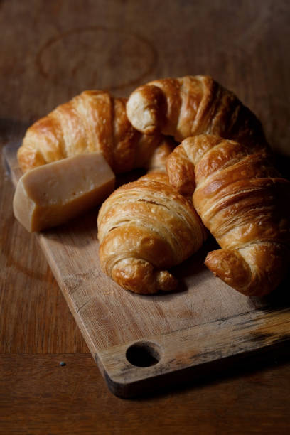 istock Four croissants on wooden board 640138584