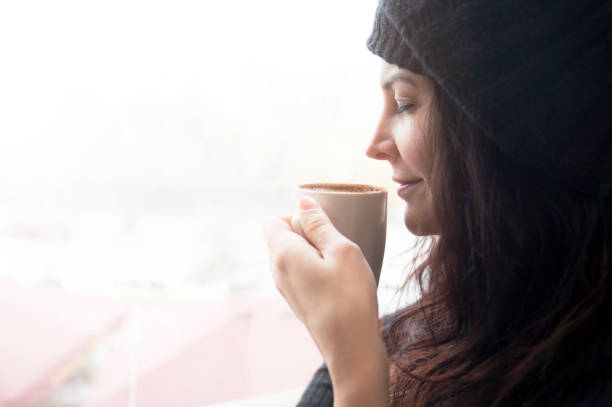 istock Young woman dreaming with cup of coffee 640138688