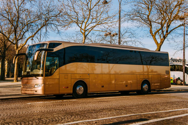 Gold coloured bus A golden coloured bus in Paris, France coach bus stock pictures, royalty-free photos & images