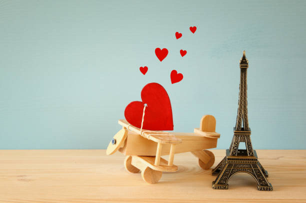 istock Wooden plane with heart next to Eiffel Tower 640139376