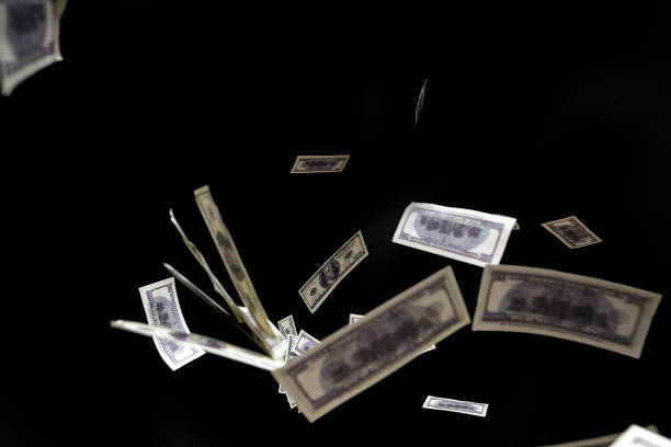 istock hundred dollars banknotes fly on black background. money rain concept 640140760