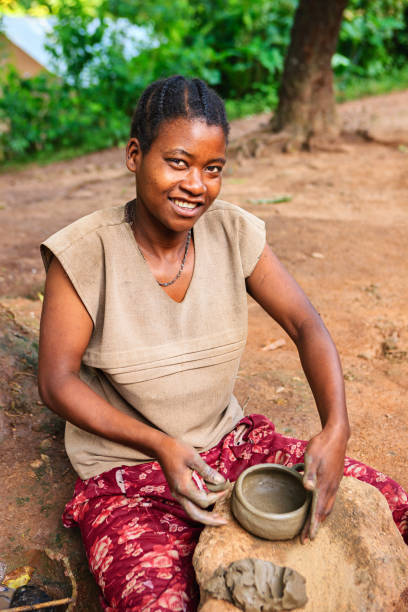 Young Ethiopian woman making pottery in the village in Omo Valley.http://bhphoto.pl/IS/ethiopia_380.jpg