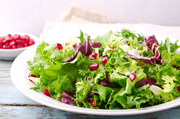 istock Green salad with spinach, frisee, arugula, radicchio and pomegranate seeds 640141950