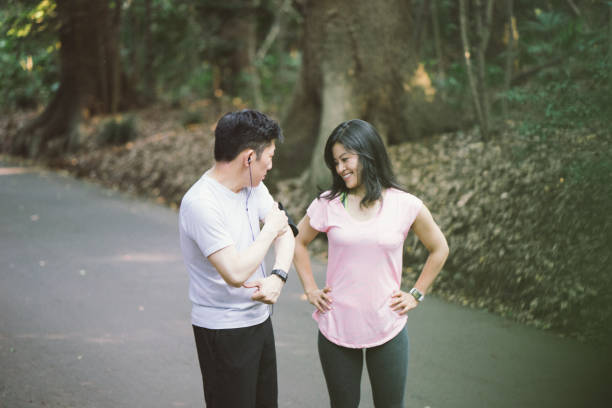 istock Japanese friends checking data on smartphone while doing sport outdoors 640142102