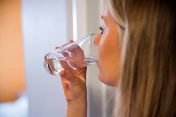 istock Happy beautiful young woman drinking water 640142130
