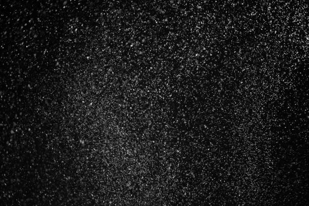 istock Falling snowflake in air dancing in wind against night sky. 640142610