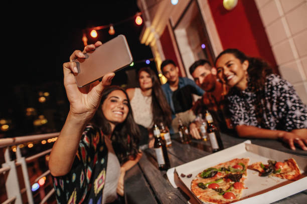 istock Group of friends making a selfie at rooftop party 640143232