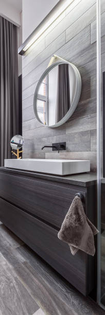 istock Wooden bathroom with round mirror 640143248