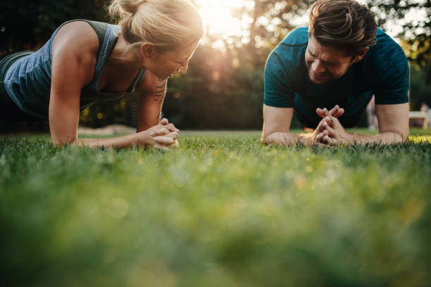 istock Healthy young couple exercising at park 640144054