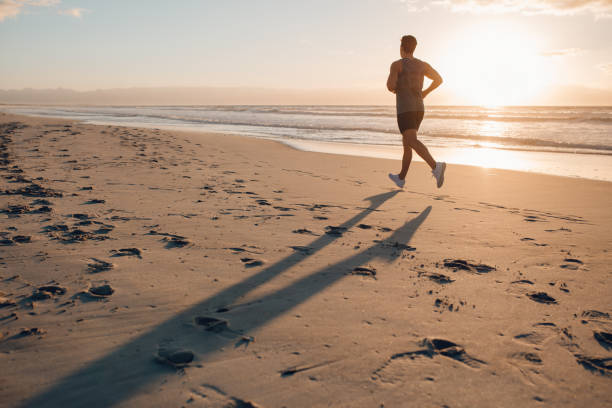 istock Man on morning run at the beach 640144234