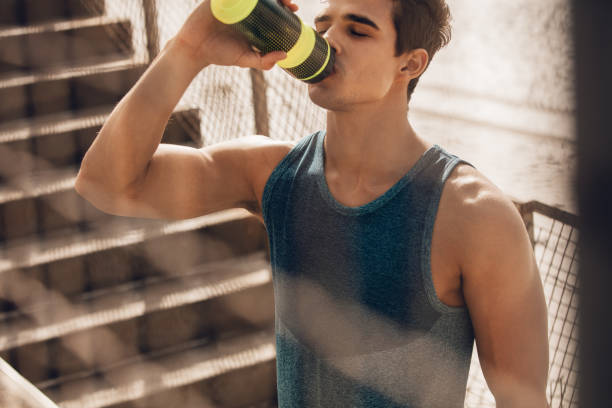 istock Muscular young man drinking water after workout 640144348