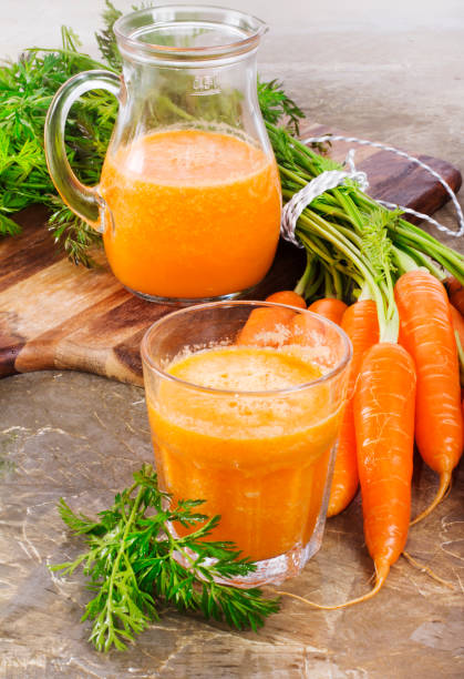 istock Fresh-squeezed carrot juice on vintage background 640144666