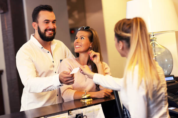 istock Couple at reception desk in hotel 640145908
