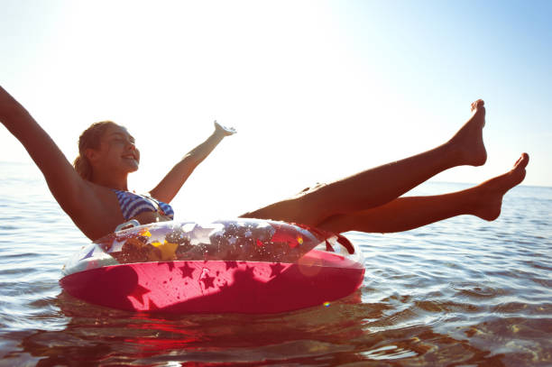 istock Unforgetable summertime enjoyment! Swimming on iflatable ring. 640145948