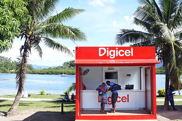 Digicel store in Fiji Savusavu, Fiji - January 9, 2017: Customers shop at a Digicel store for mobile phones in Savusavu. It is a mobile phone network provider operating in 33 markets across the Caribbean, Central America, and Oceania regions. It has about 13 million wireless users. vanua levu island photos stock pictures, royalty-free photos & images