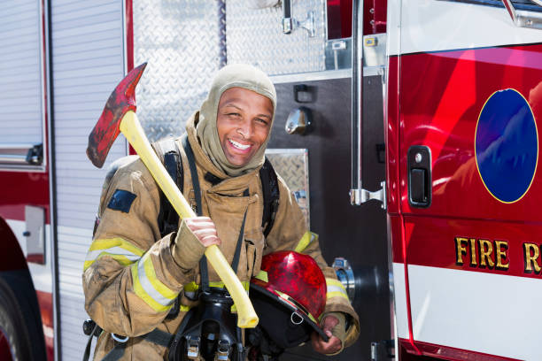 istock African American fire fighter carrying axe 640146496