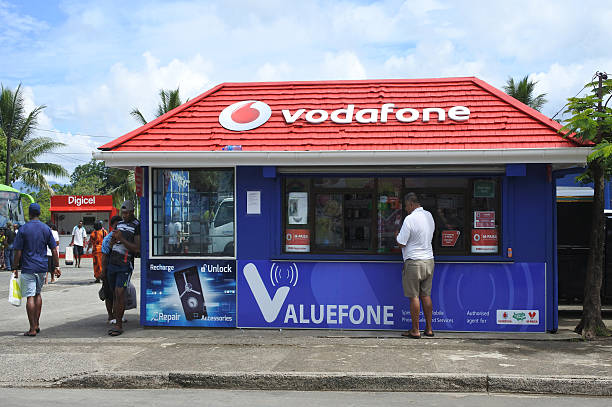 Vodafone Fiji store Savusavu, Fiji - January 19, 2017: Customers shop at a Vodafone Fiji store. Vodafone serve 30 countries with over 400 million mobile customers and 12 million fixed broadband customers. vanua levu island photos stock pictures, royalty-free photos & images