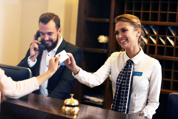 Guests getting key card in hotel Picture of guests getting key card in hotel file clerk stock pictures, royalty-free photos & images