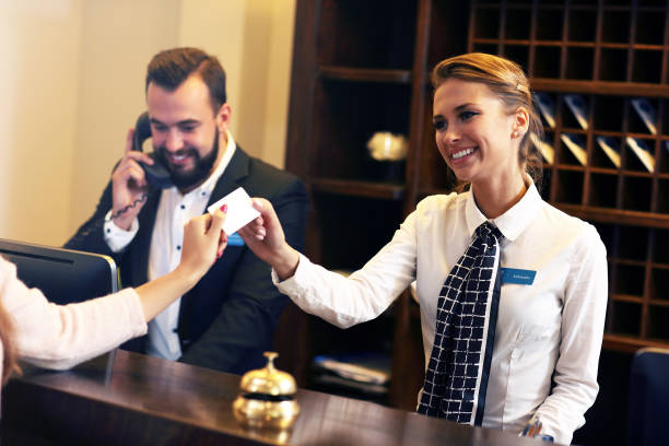 guests getting key card in hotel - hotel desk reception imagens e fotografias de stock