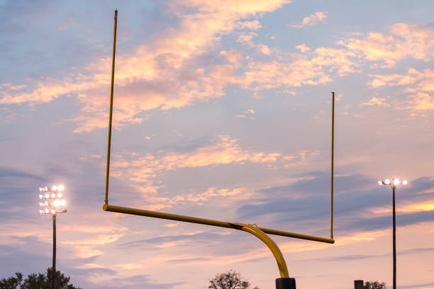 istock American football goal posts against sunset 640148552