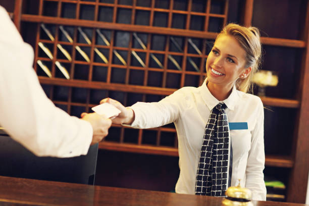 istock Pretty receptionist giving key card 640148734