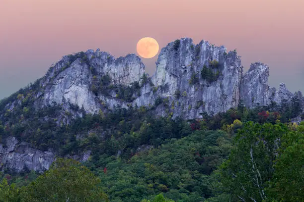 Composite of the supermoon over the rocky mountain top of Seneca Rocks in West Virginia