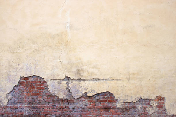 istock Old brick wall with peeling plaster, grunge background 640151816