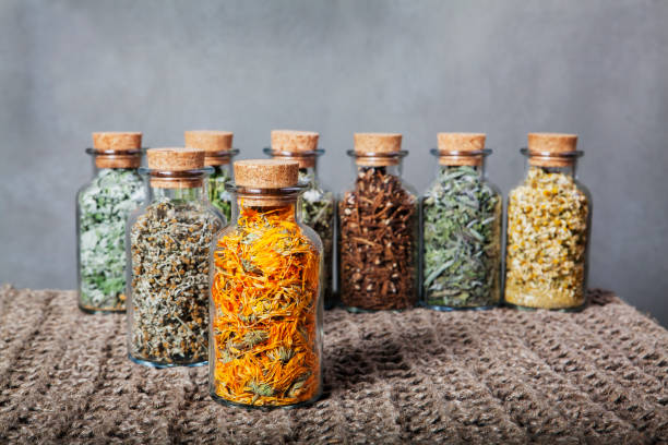 istock Different kinds of herbs for tea inside glass bottles. 640152418