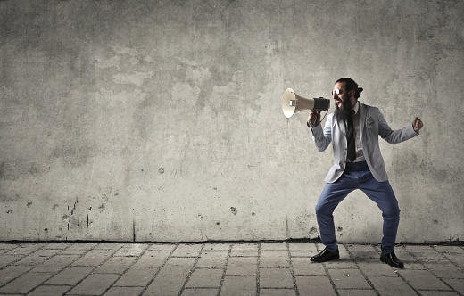 Screaming man with megaphone in his hand