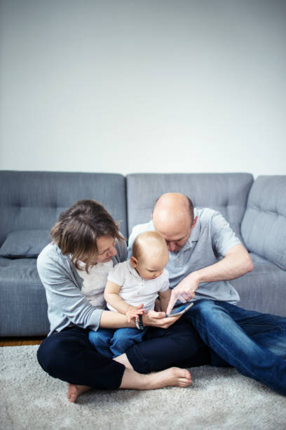 istock Family with a child using a smartphone 640156944