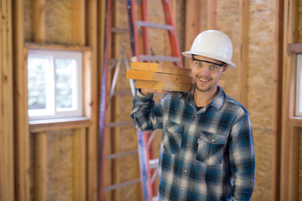 istock Male contractor holding 2x4's and smiling at camera 640157070
