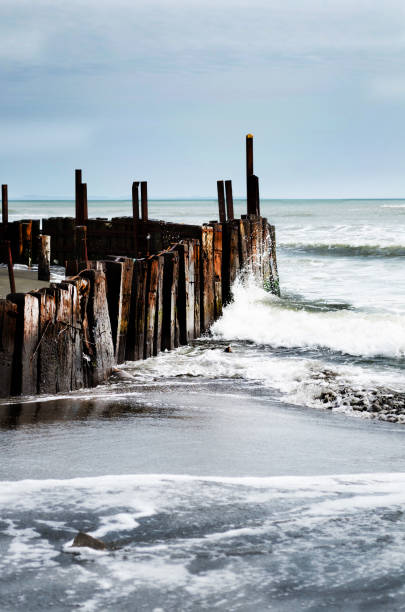 istock Waves crashing onto wooden posts on sea shore 640157888