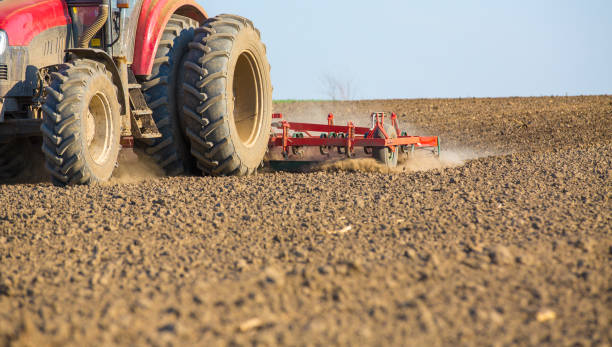 istock Farmer in tractor preparing land with seedbed cultivator. 640160582