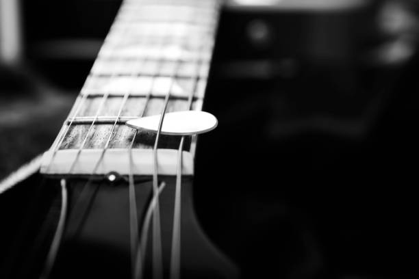 istock Acoustic guitar with piectrum  in dark background 640160706