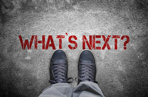 What`s next? stencil print with sneakers on concrete floor top view