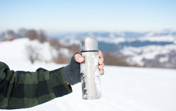 istock Man holding a thermos on hiking trip 640163570