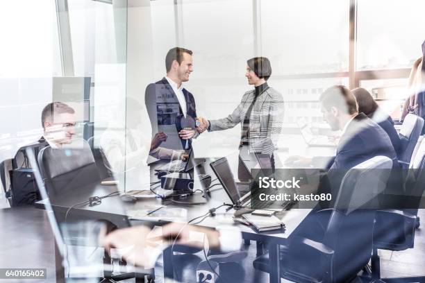 Business People Shaking Hands In Moder Corporate Office Stock Photo - Download Image Now