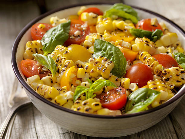 Grilled Corn Salad with Tomatoes and Basil Grilled Corn Salad with Tomatoes and Basil  -Photographed on Hasselblad H3D2-39mb Camera corn salad stock pictures, royalty-free photos & images