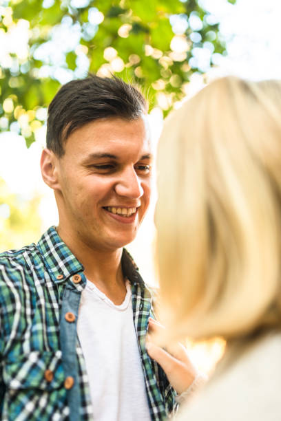 istock romantic couple flirting in the park 640166054