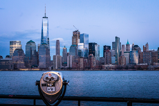 The Freedom Tower and Manhattan skyline, shot from Liberty State Park. A coin-operated viewfinder is in the foreground